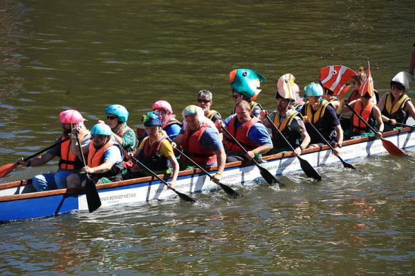 The AAM Sea's the Day team rowing in a Dragon Boat in 2022