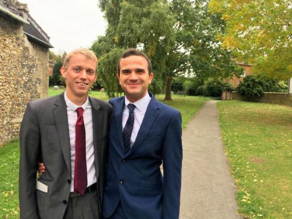 Peter and Nic, a newlywed couple stand together on their wedding day