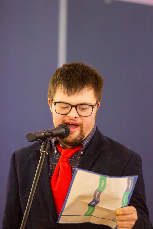 A young man singing into a microphone