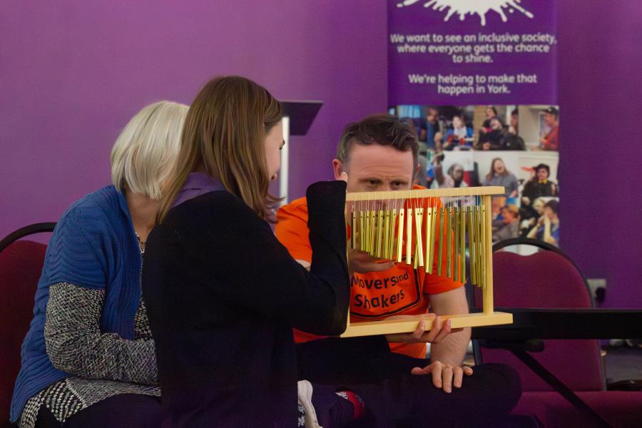 A member of Movers & Shakers playing some chimes