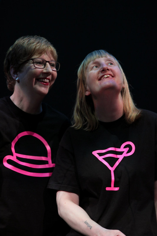 Two performers look upwards during a performance of the play Cabaret of Dreams