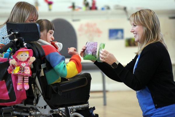 A IMPs Holiday Club participant picks a photo 