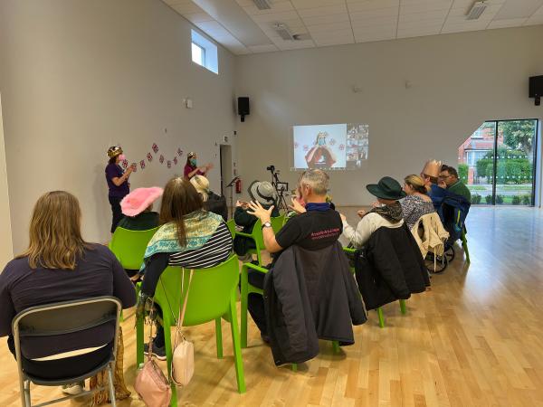 Image shows AAMs Hands and Voices Choir in a Hybrid session